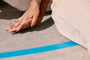 a person sitting on the ground with their hand on the ground
