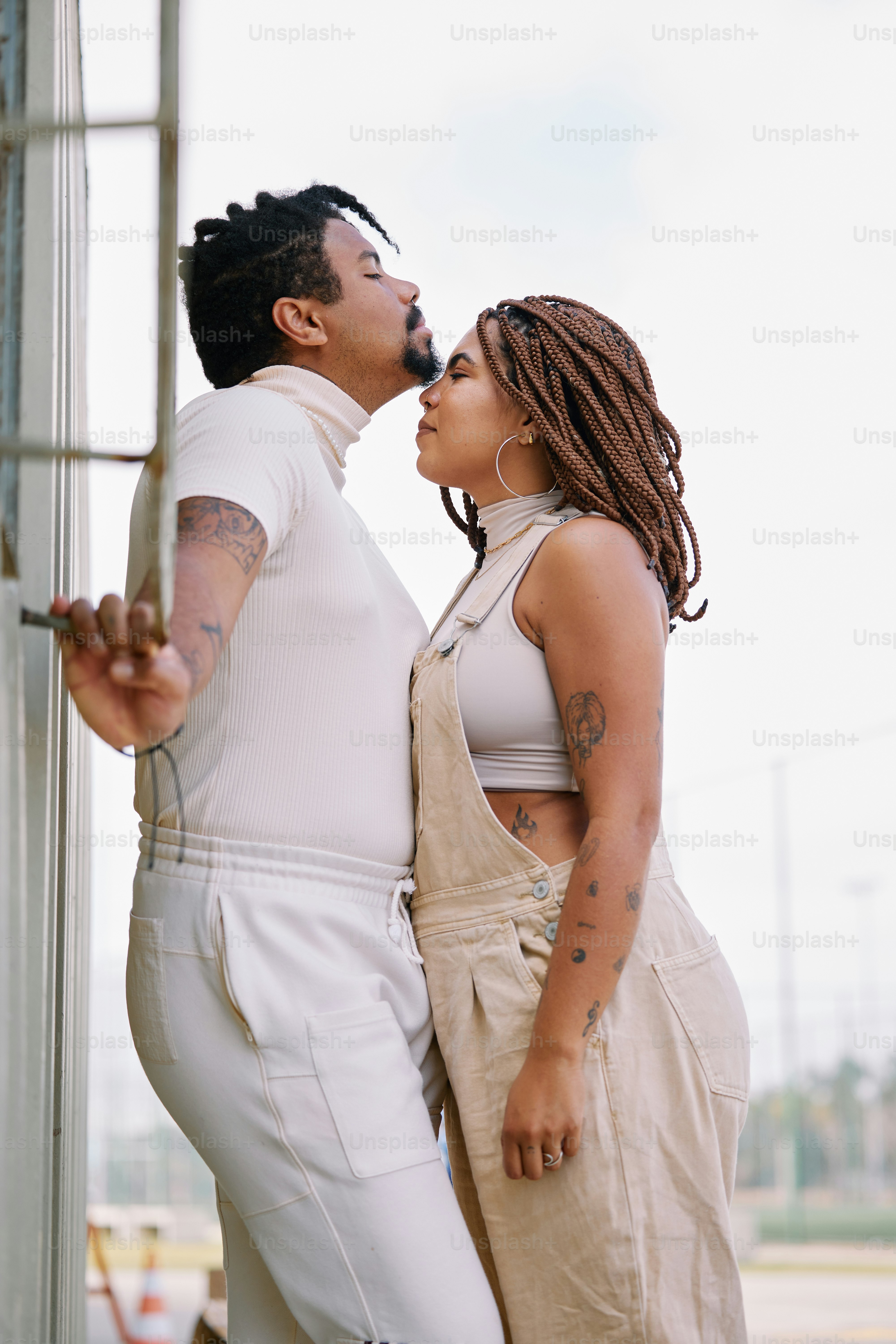 A man and a woman standing next to each other photo – Fashion Image on ...