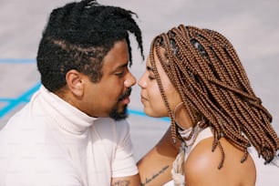 a man and a woman with dreadlocks on their heads