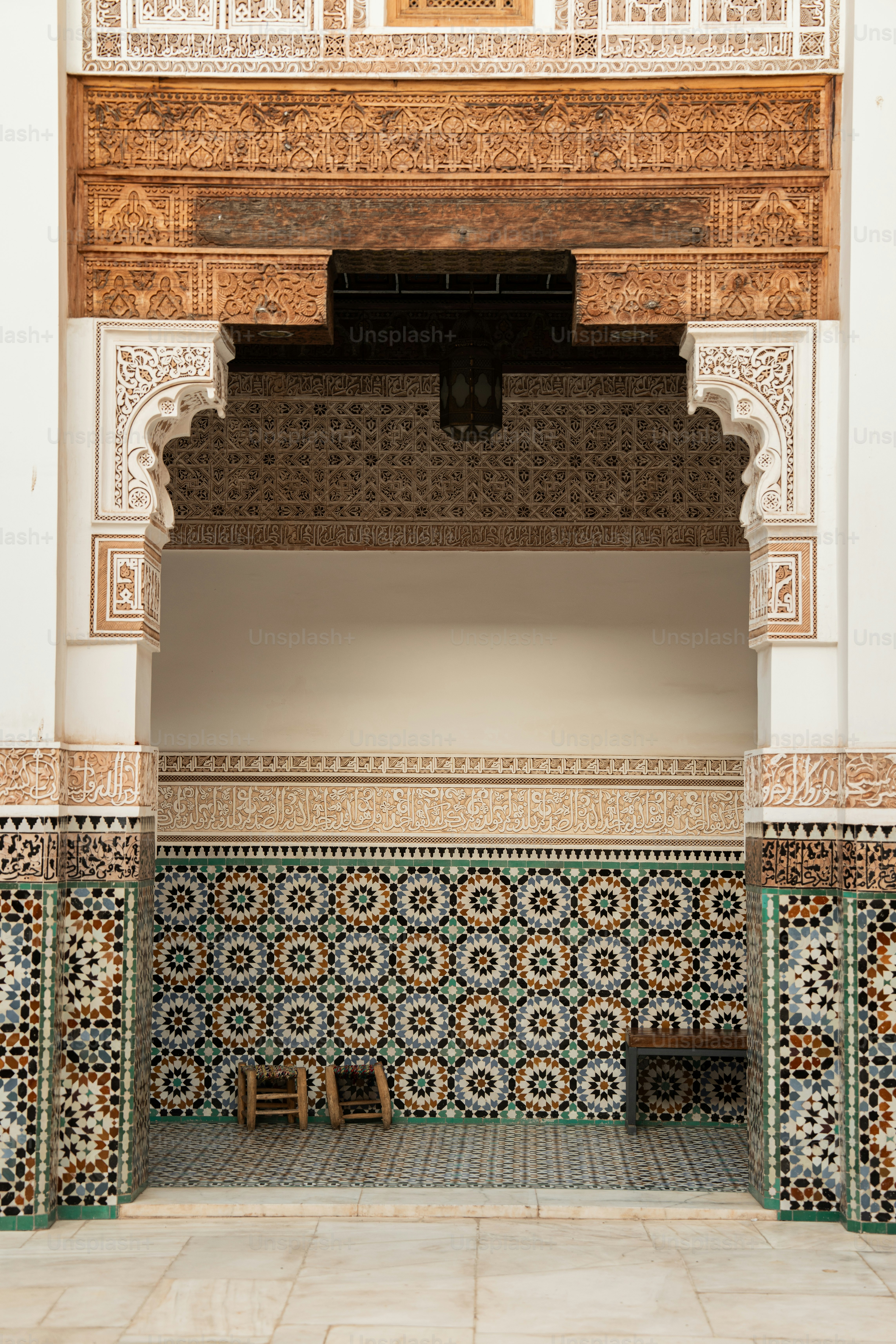 a room with a tiled wall and a bench
