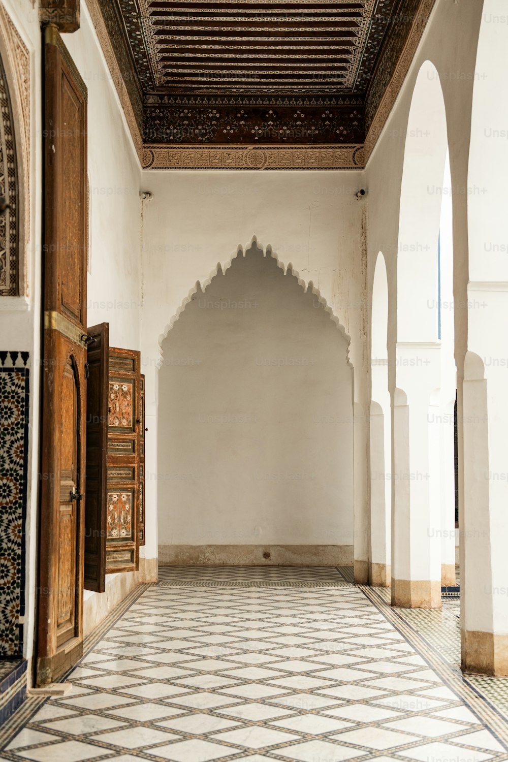 a room with a tiled floor and a wooden door