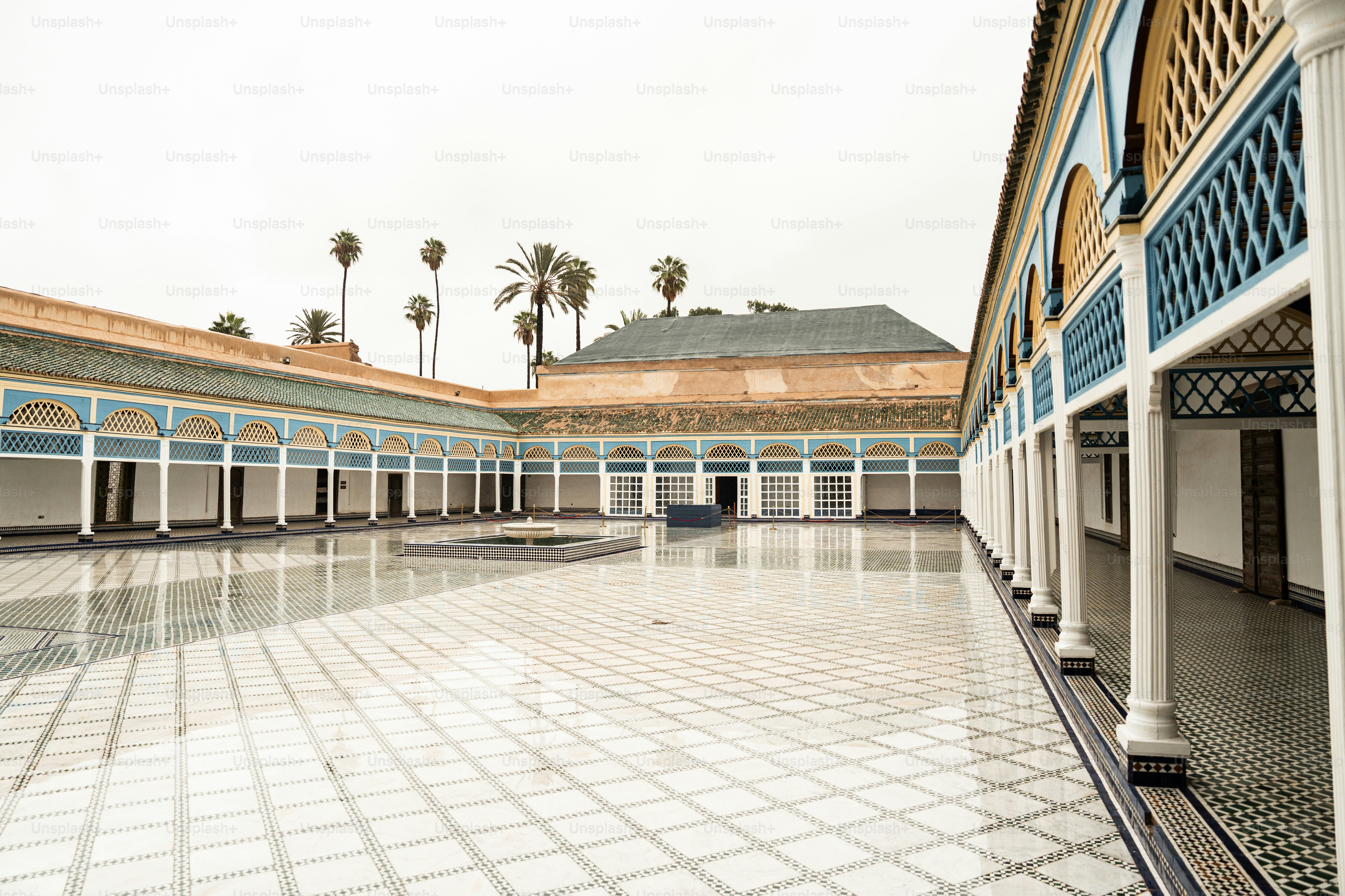 a courtyard with a tiled floor and columns