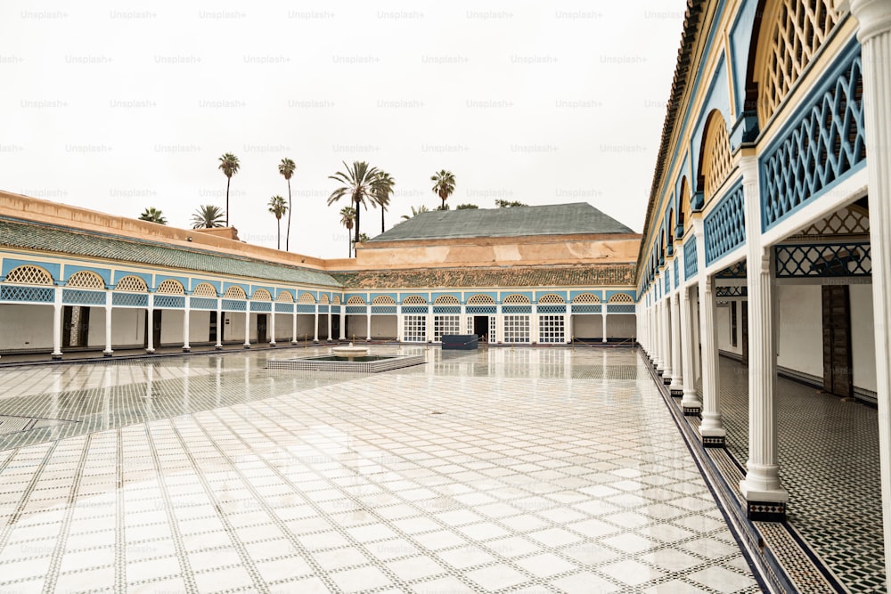 a courtyard with a tiled floor and columns