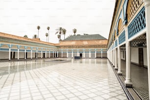 a courtyard with a tiled floor and columns