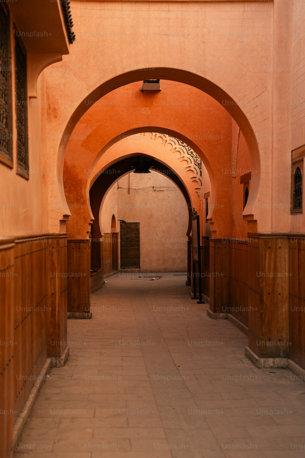an archway leading to a building with a clock on it
