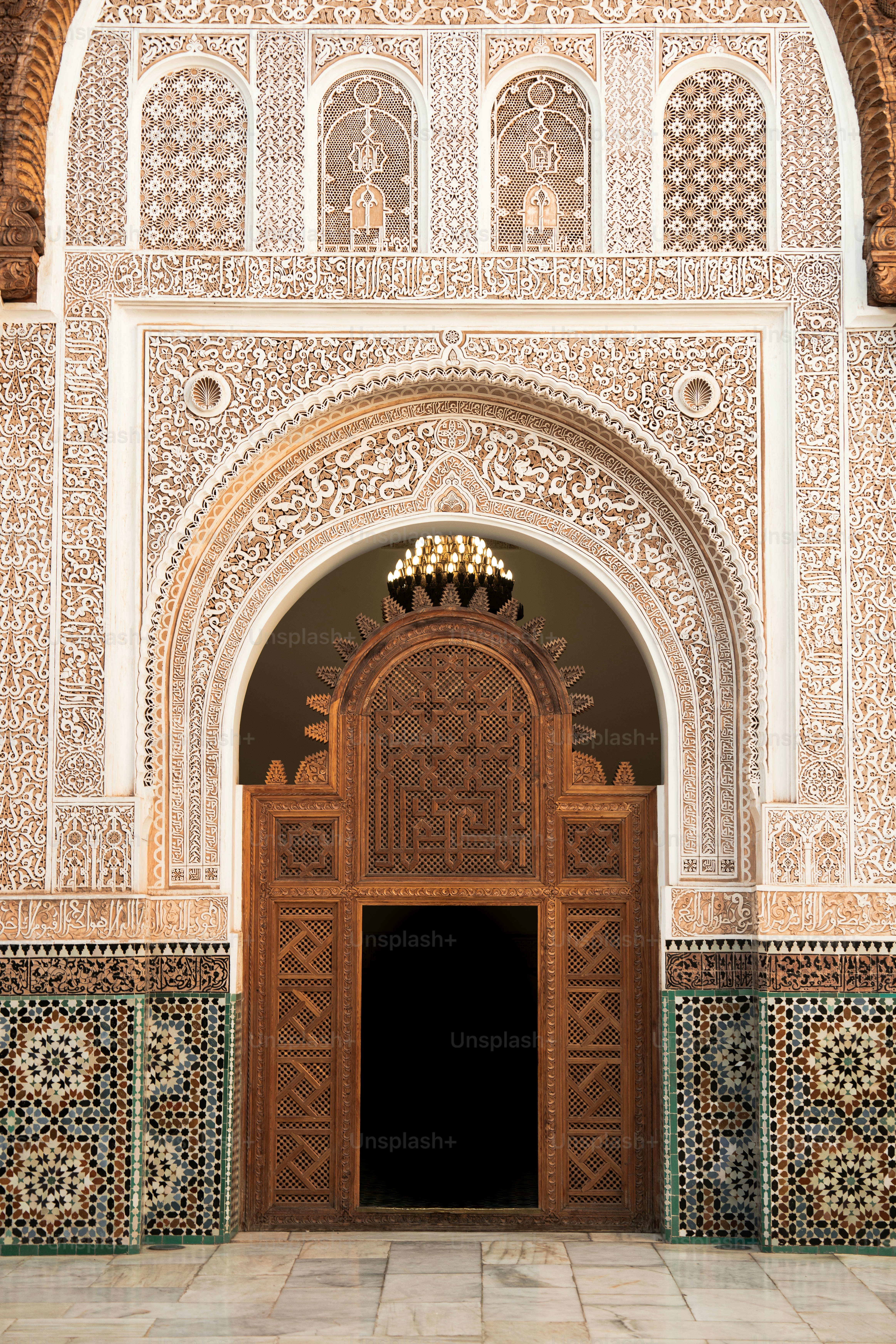 an ornate doorway with a chandelier above it