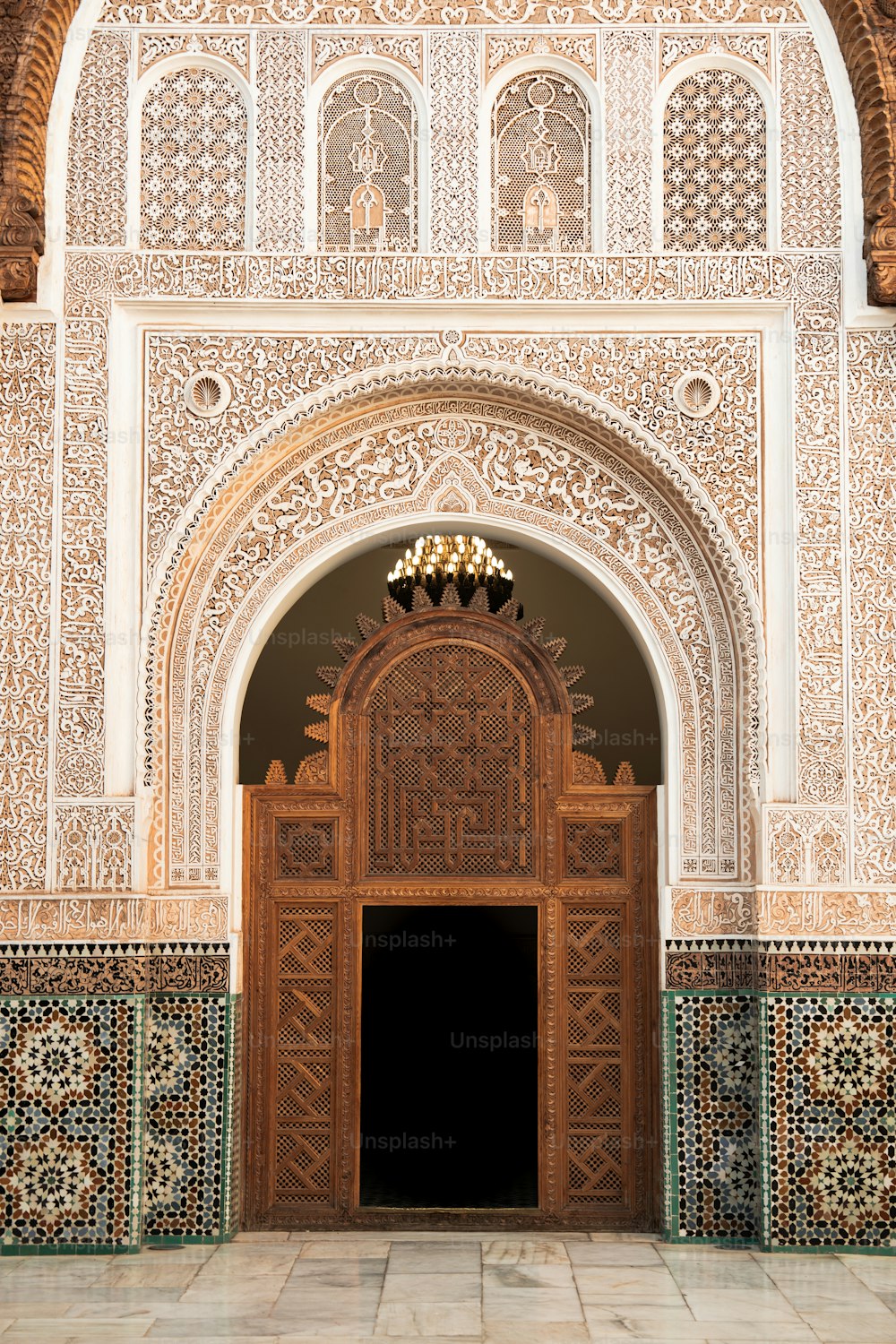 an ornate doorway with a chandelier above it