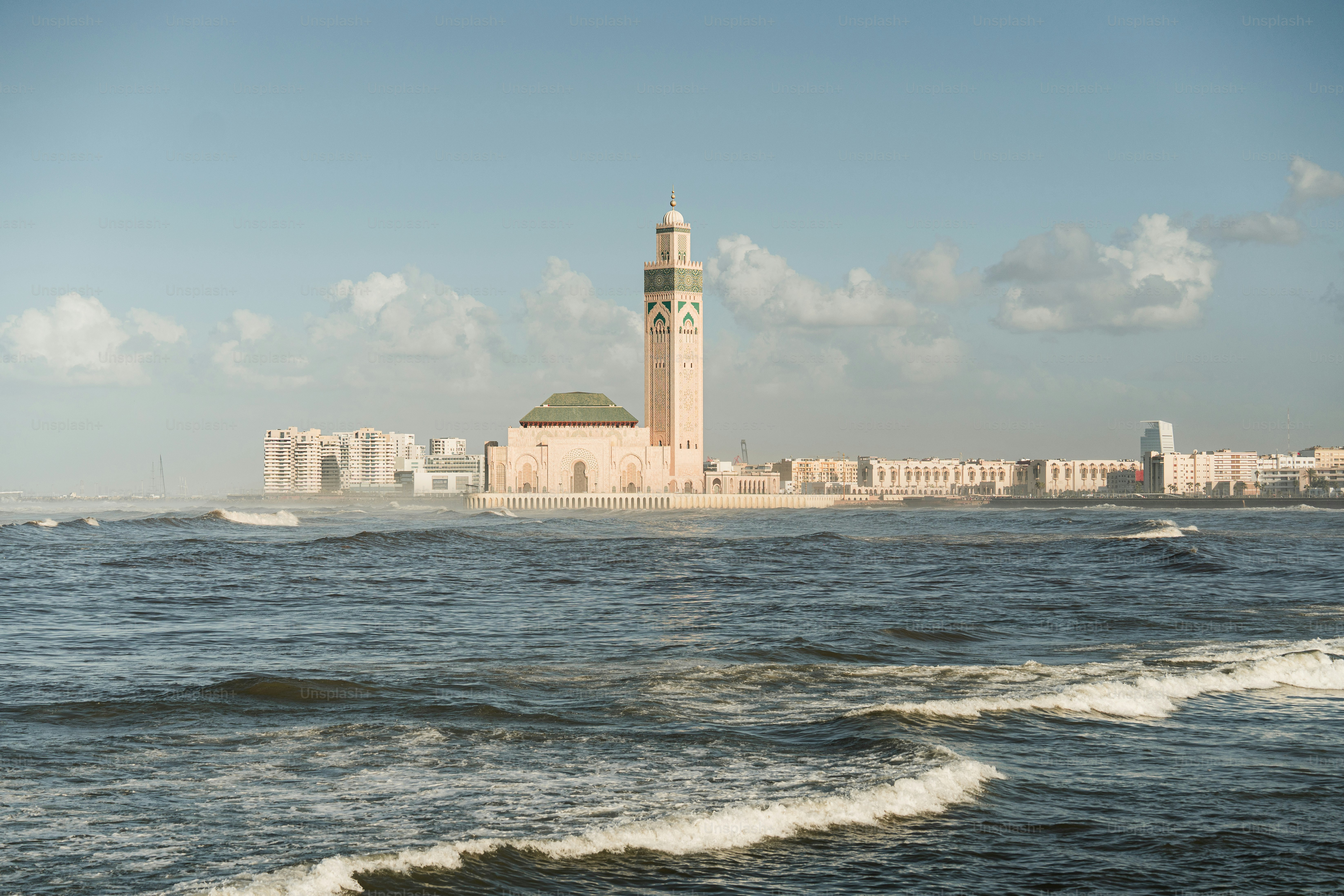 a clock tower in the middle of a body of water