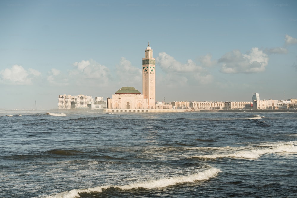 a clock tower in the middle of a body of water