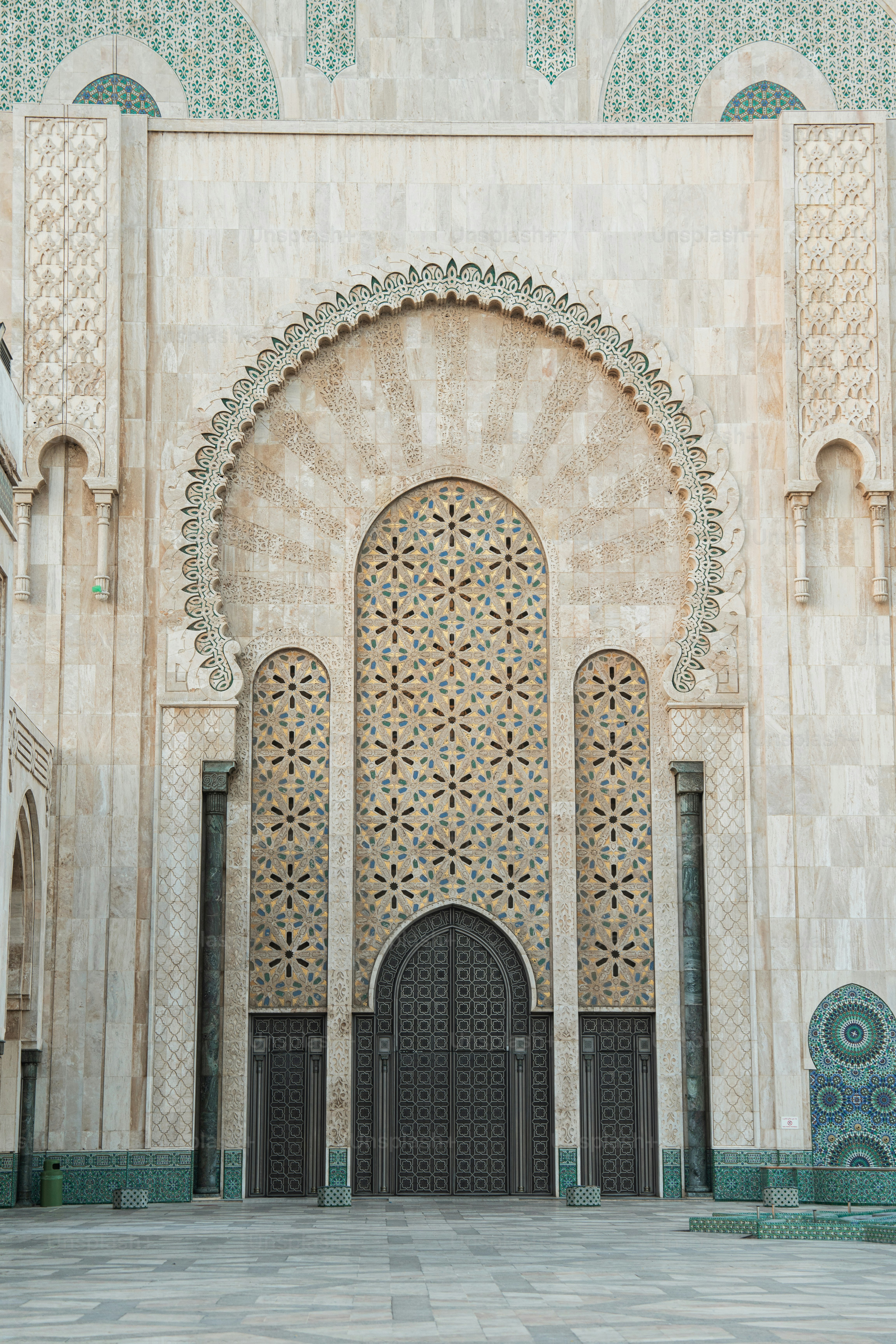 a large building with a large doorway and a clock on the wall