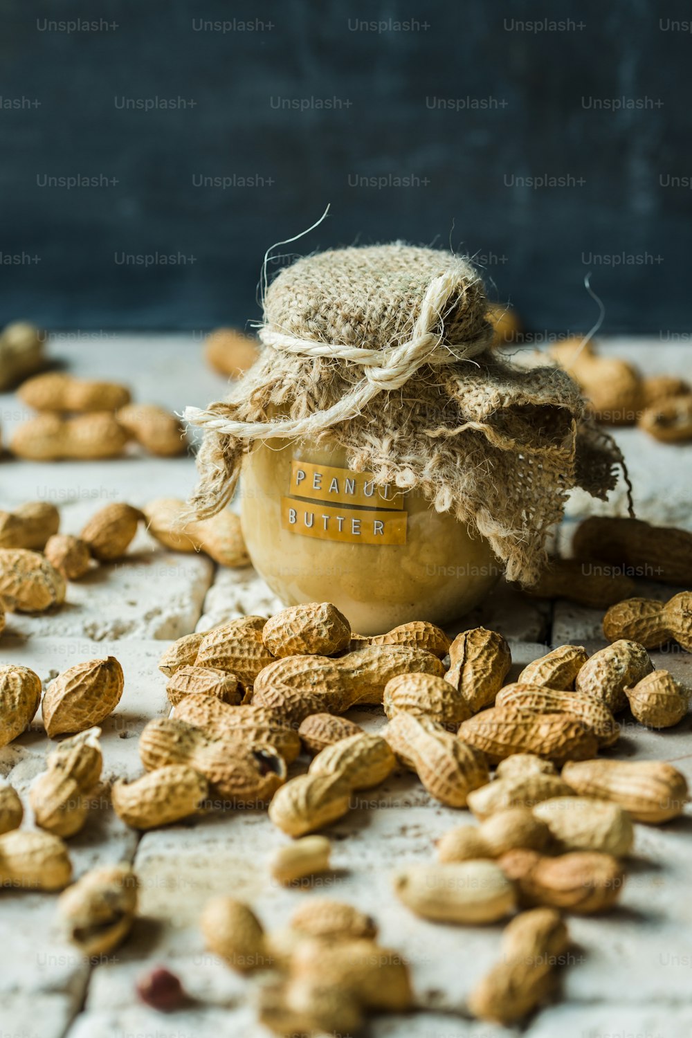 a jar filled with peanuts sitting on top of a table