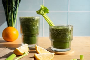 a couple of glasses filled with green liquid