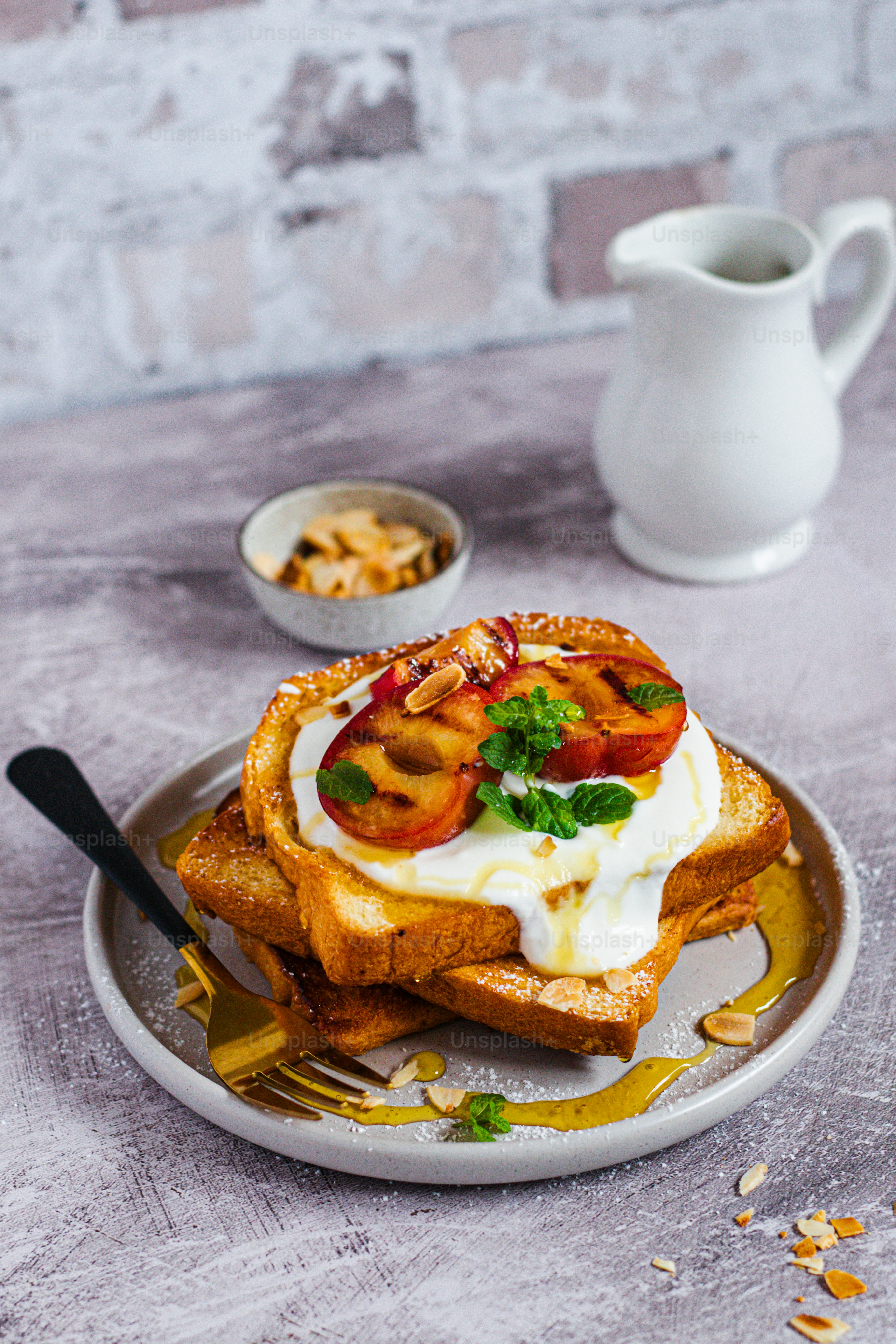 a plate of food on a table next to a cup of coffee
