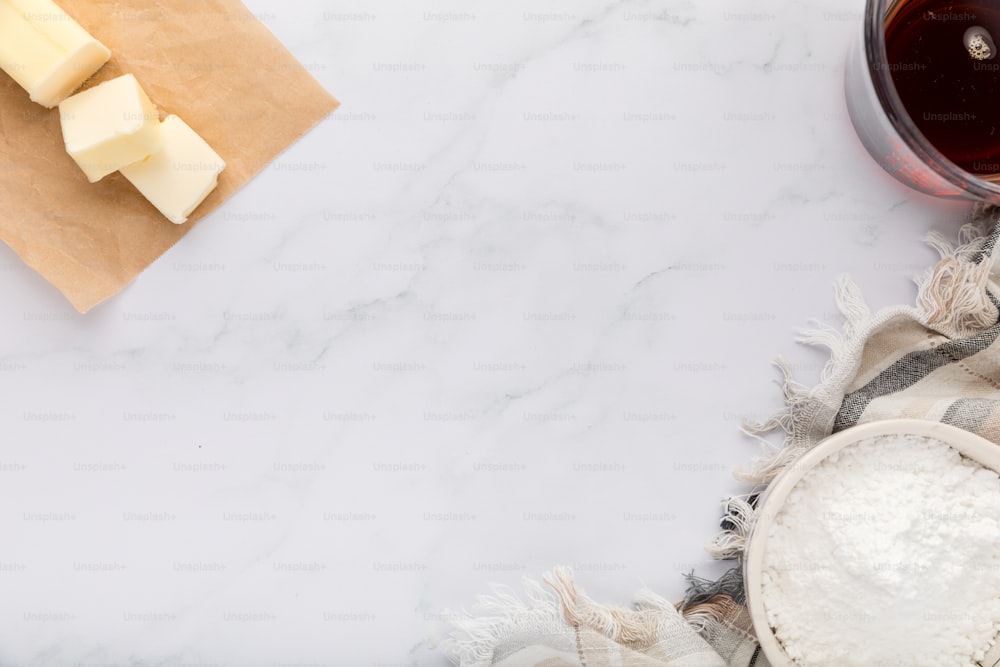 a block of butter and jug of flour with copy space