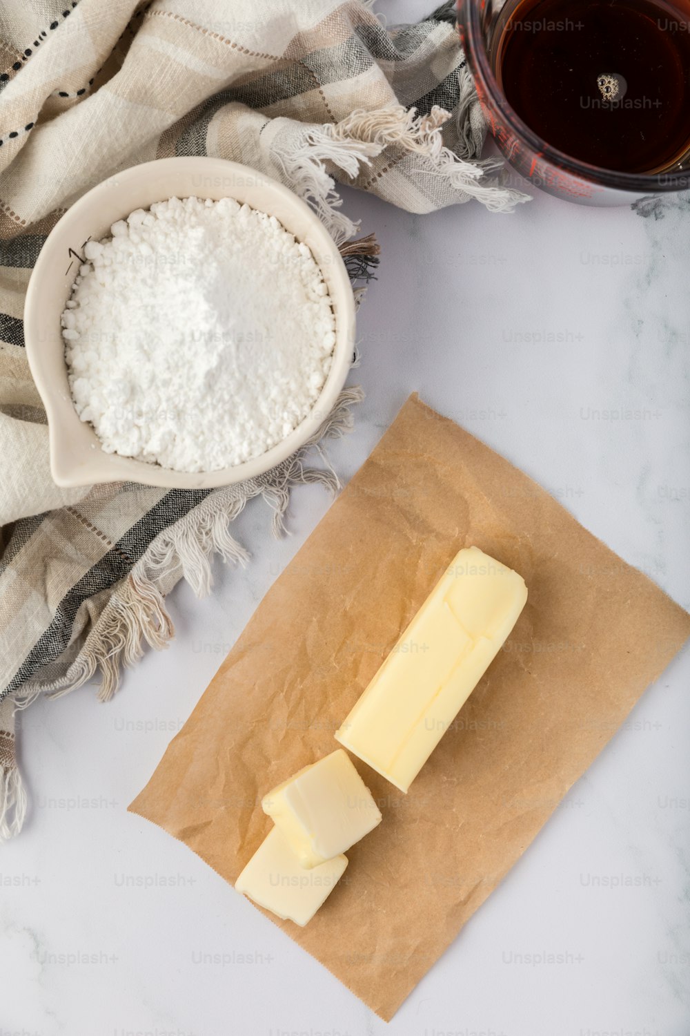 a block of butter and jug of flour