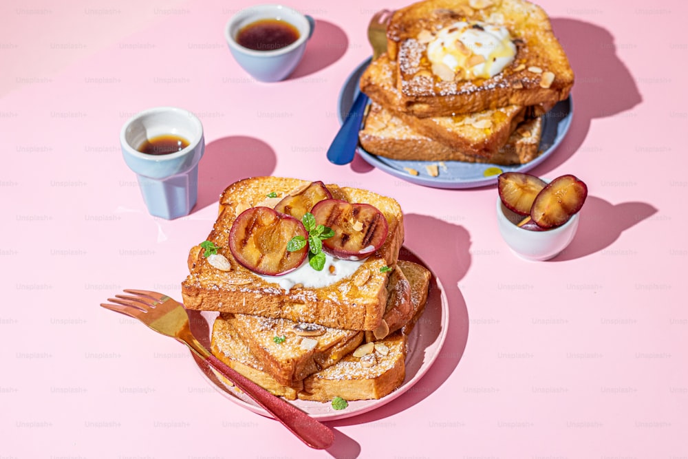 a pink table topped with a plate of french toast