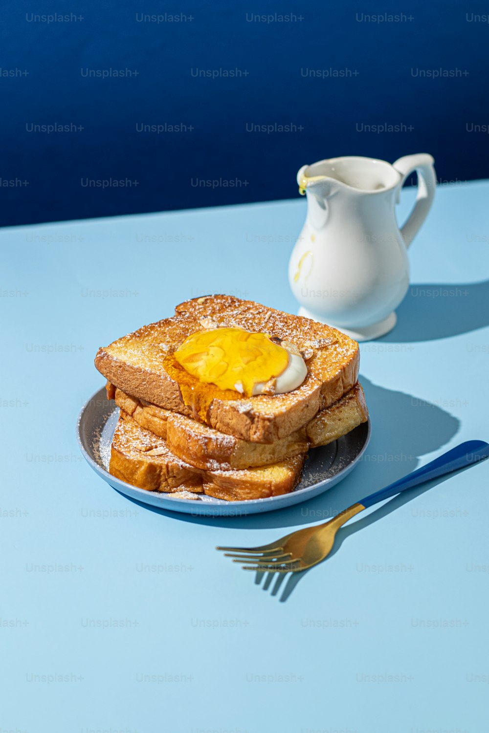 a plate of french toast with an egg on top