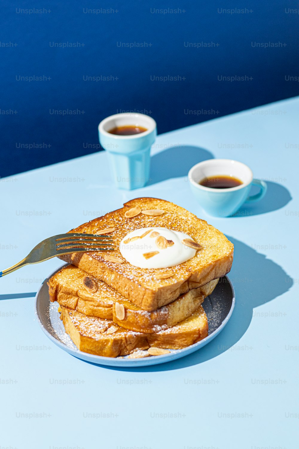 a plate of french toast with butter and syrup