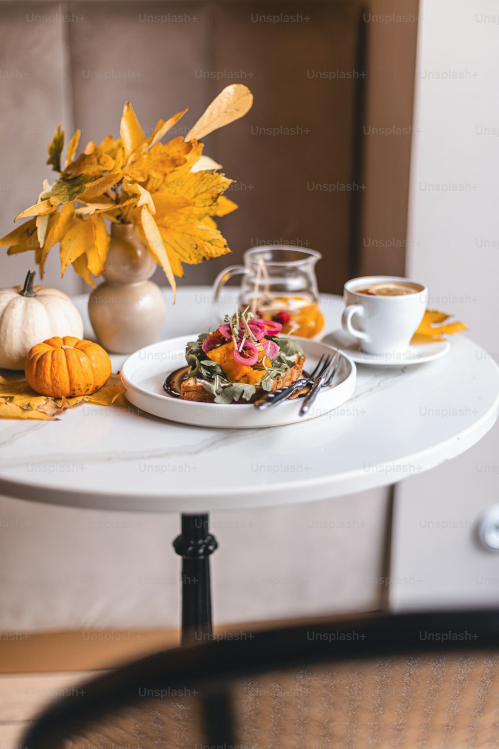 a white table topped with a plate of food