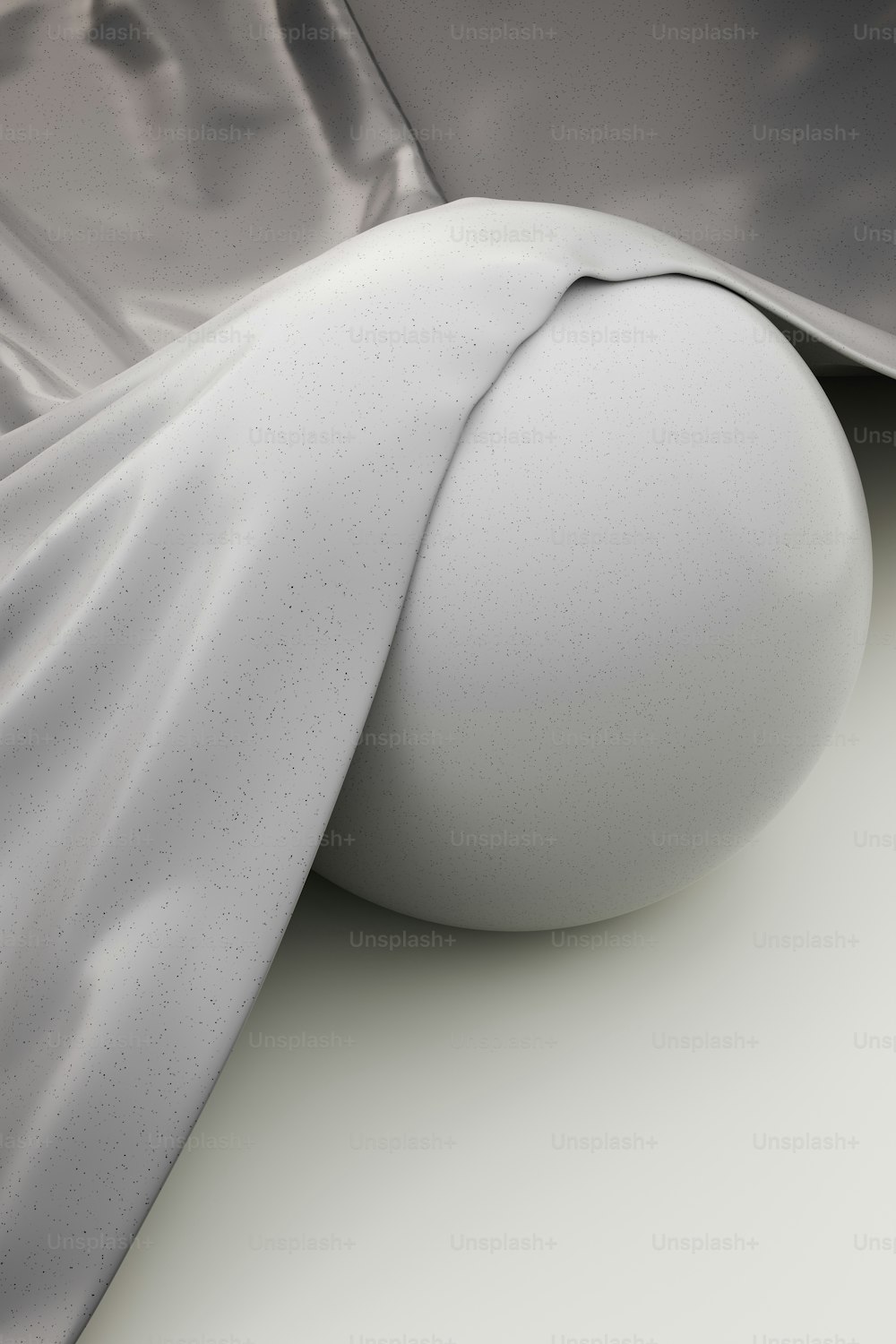 a white ball sitting on top of a white surface