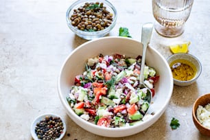 a white bowl filled with a salad next to other bowls of food