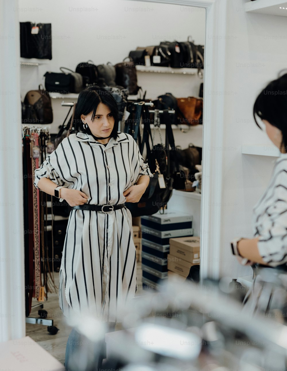 a woman standing in front of a mirror