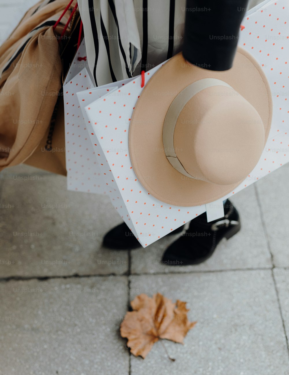 a person with a hat and shopping bags