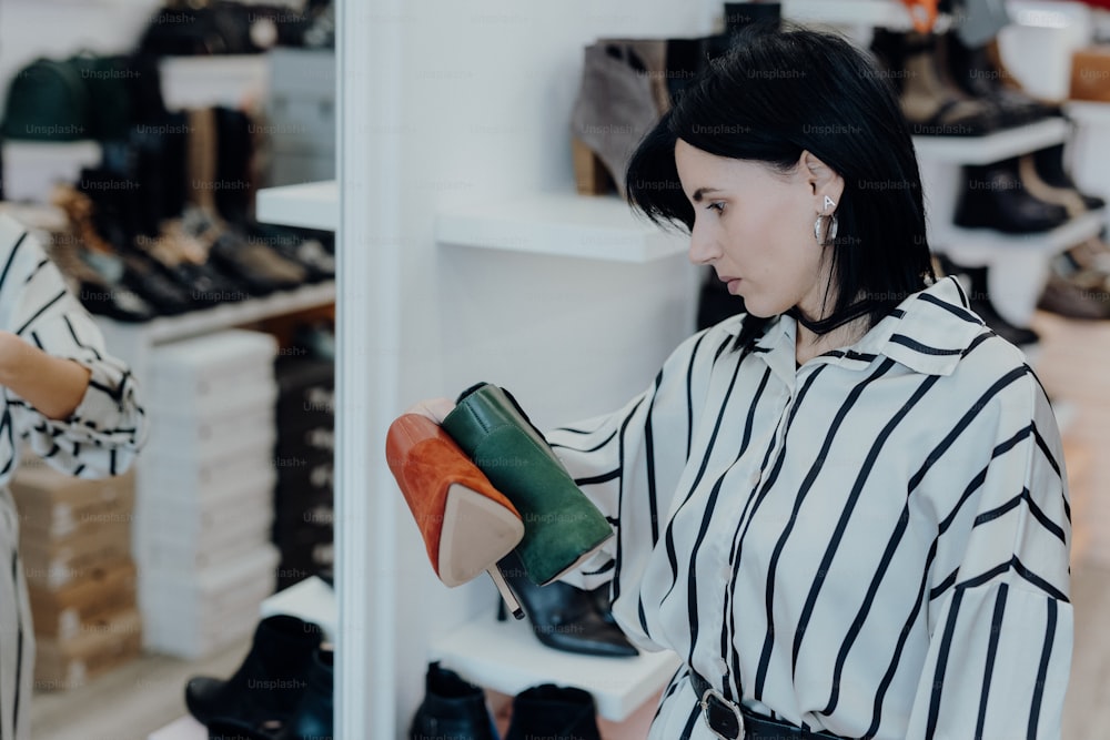 a woman looking at a pair of shoes in a shoe store