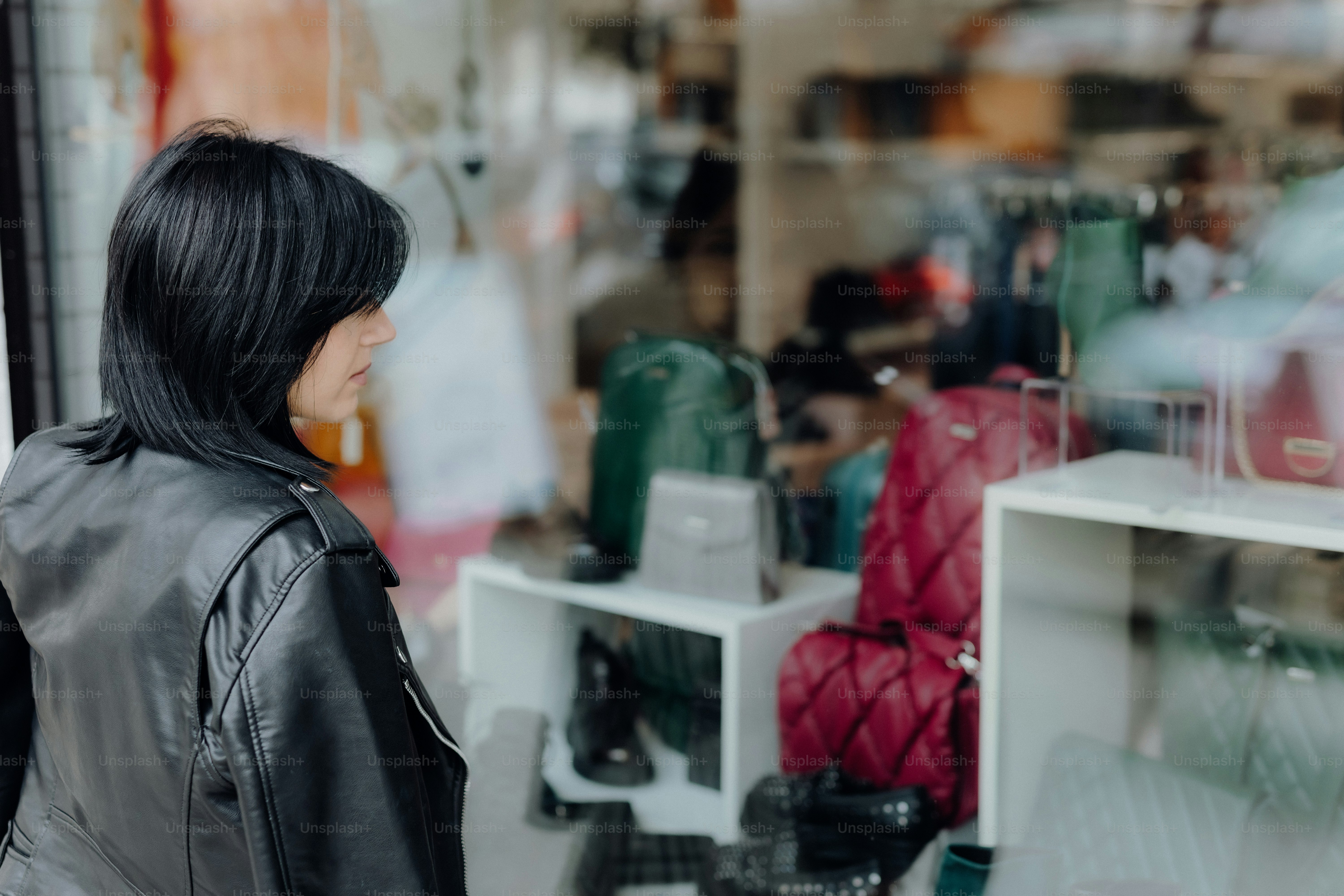 a woman standing in front of a store window