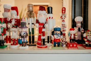 a collection of nutcrackers and figurines on a shelf