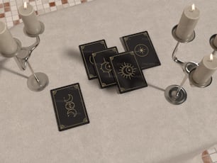 a table topped with cards and candles on top of a table