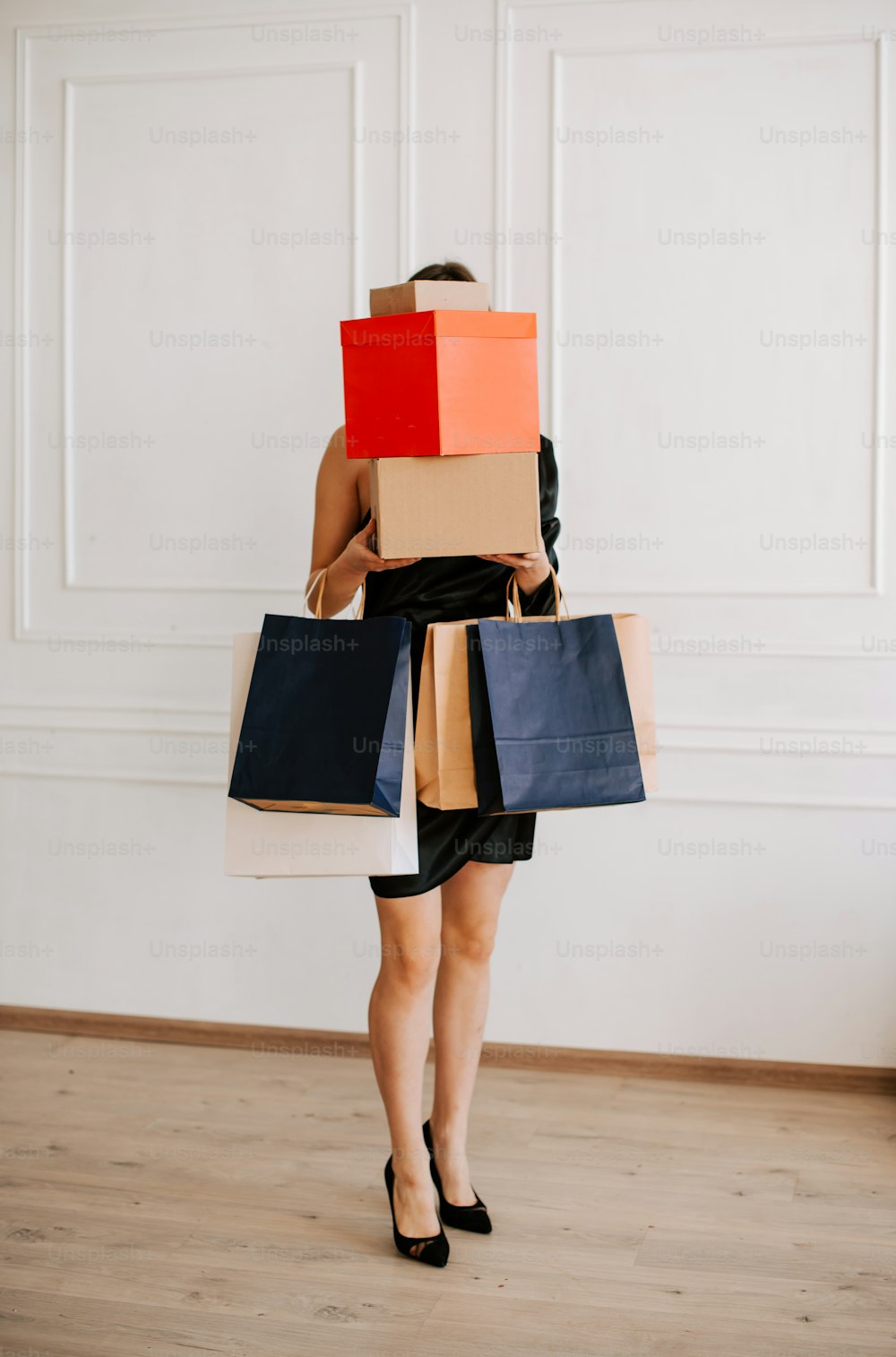 a woman carrying a bunch of shopping bags