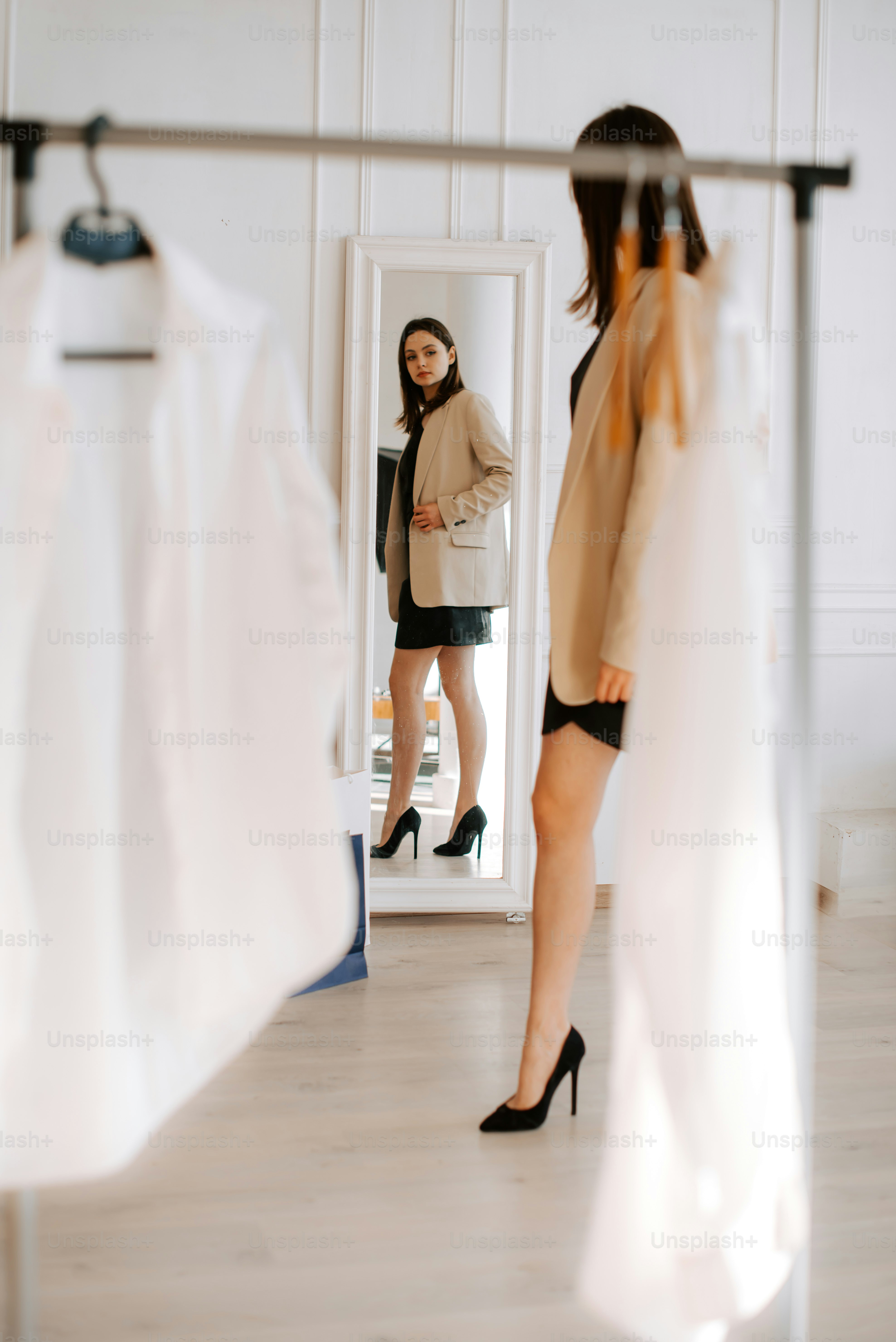 a woman standing in front of a mirror