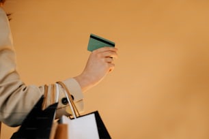 a woman holding a credit card and a shopping bag