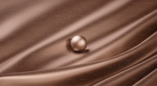 a close up of a brown fabric with a ball on it