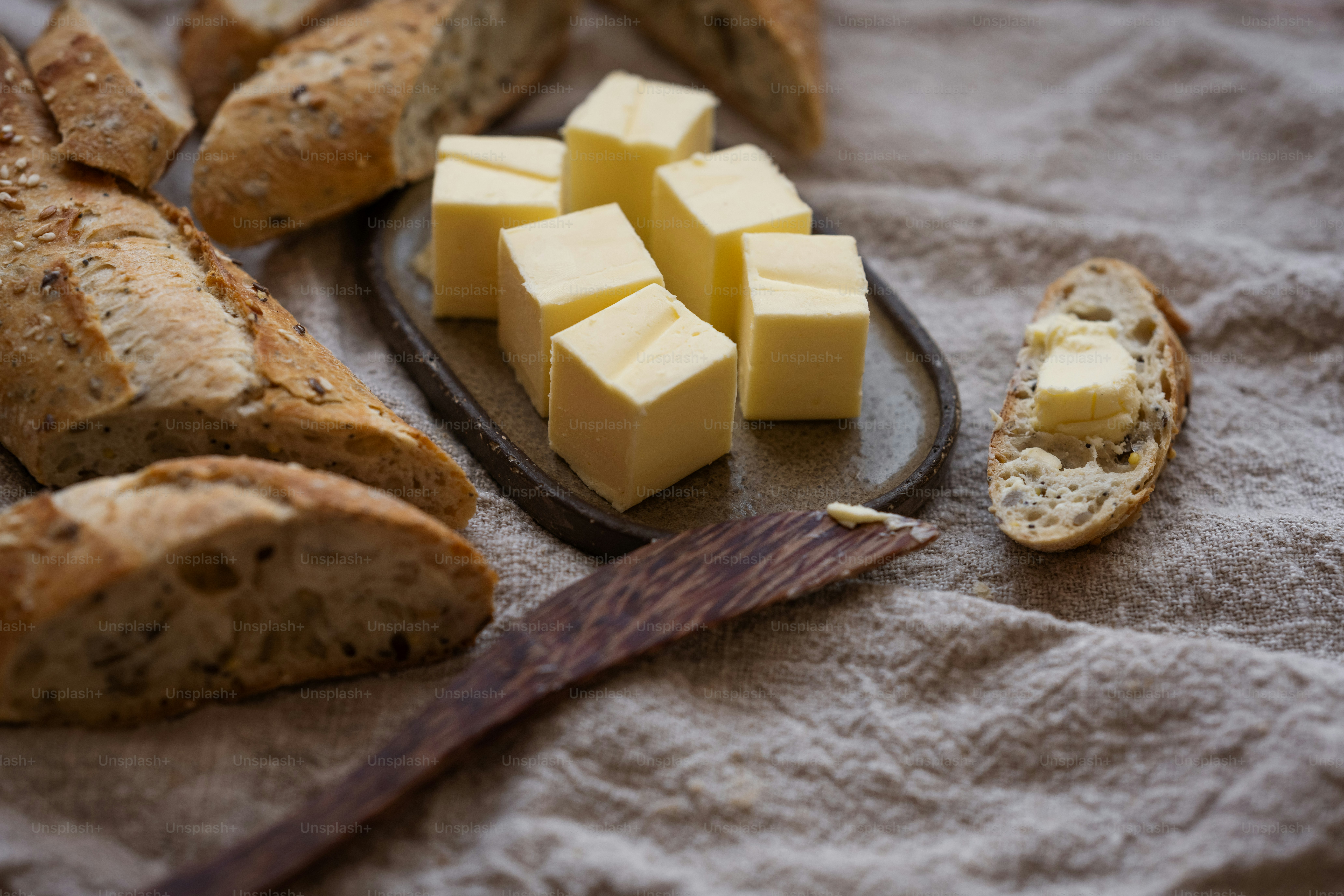 Bread, butter, and buttered bread on a plate photo – Food photography ...