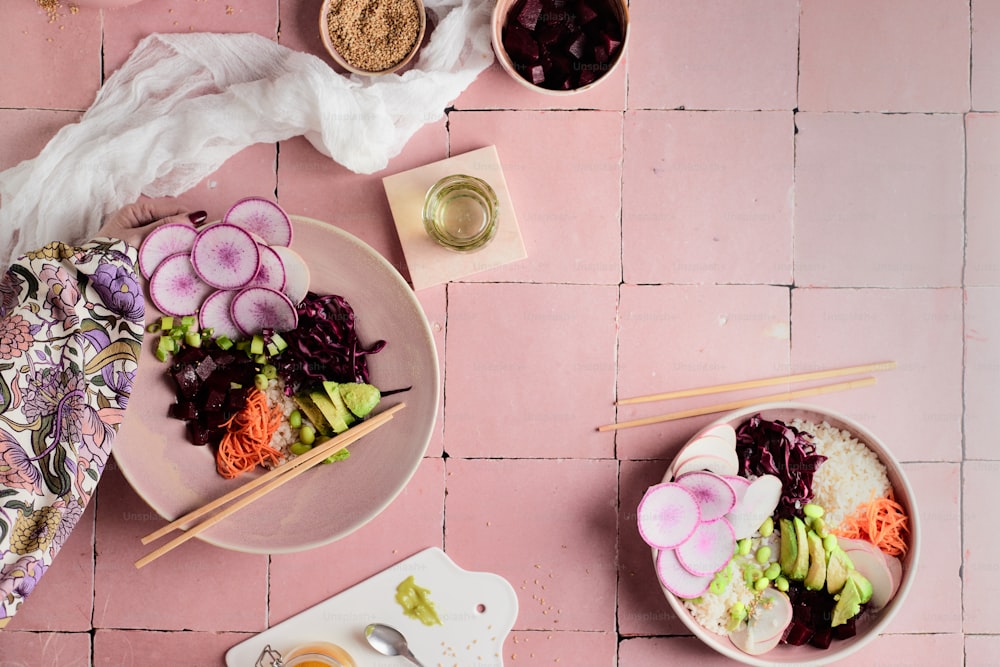 a table topped with bowls of food and chopsticks