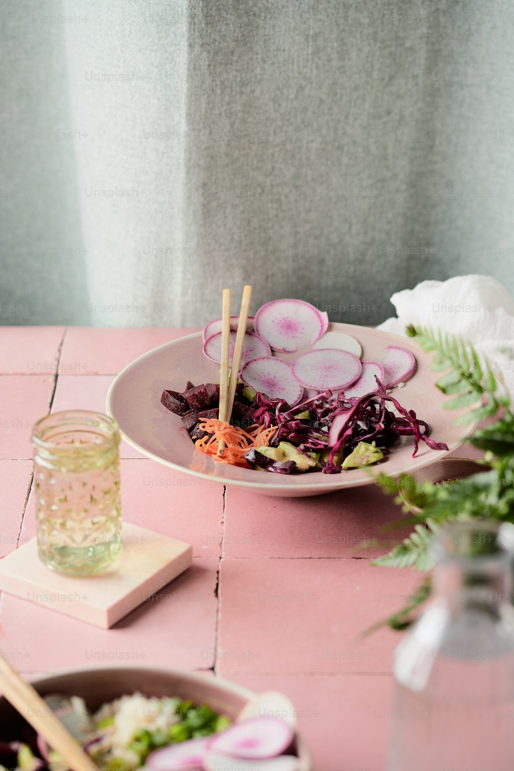 a plate of food on a pink table