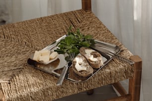 a tray of cheese and bread on a chair