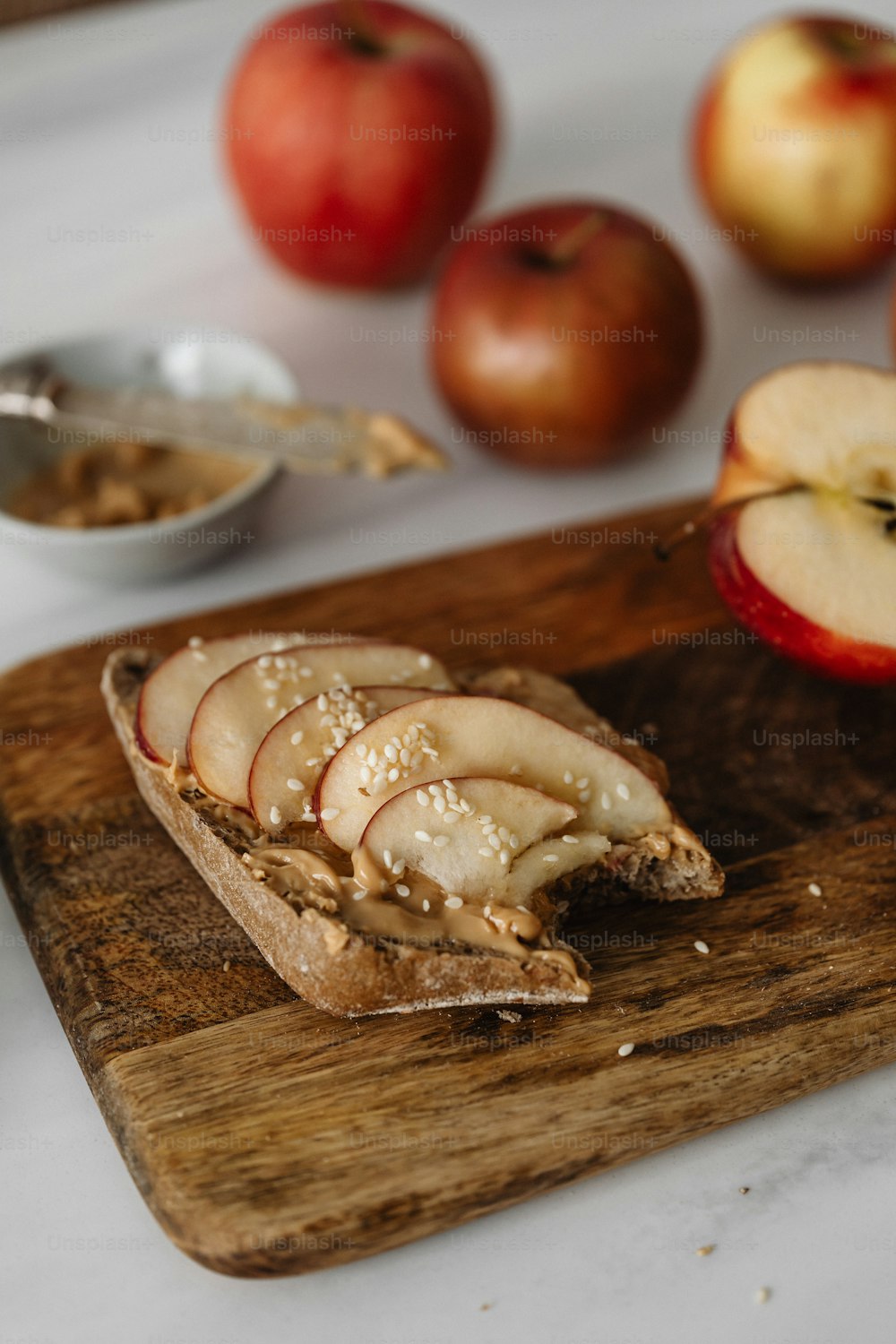 a wooden cutting board topped with sliced apples