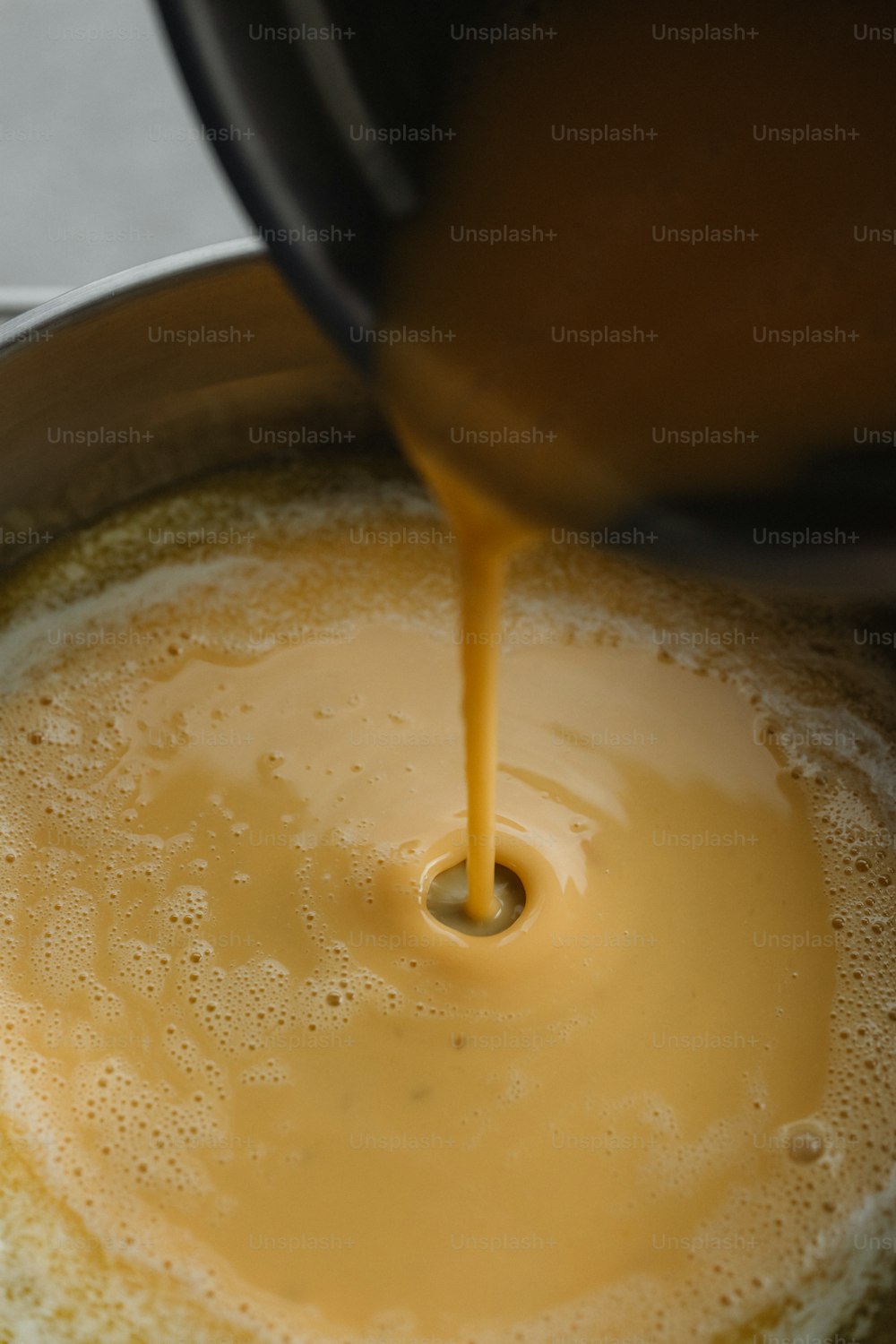 a pot filled with liquid being poured into it