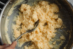 a spoon in a pot of food on a stove