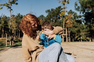 a woman sitting on the ground with a child