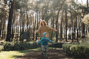 a woman and a child are playing frisbee in the woods