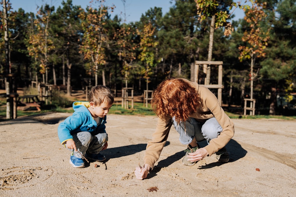 a woman and a child playing in the sand