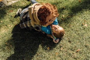 a boy and a boy are playing in the grass