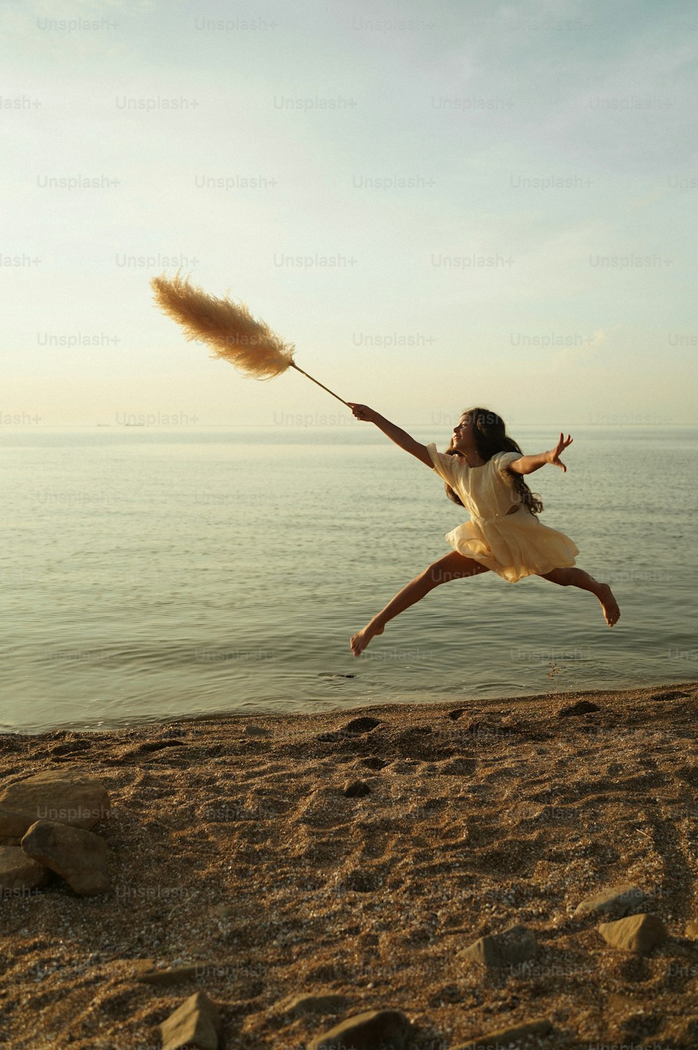 a woman jumping in the air while holding a broom