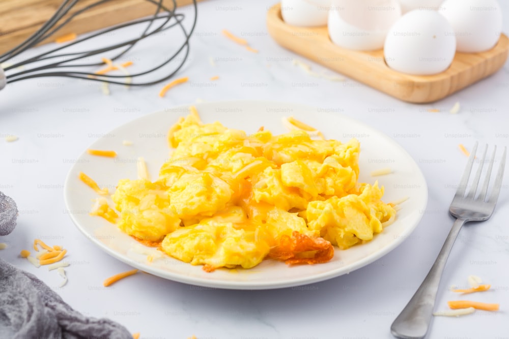 a plate of scrambled eggs on a table