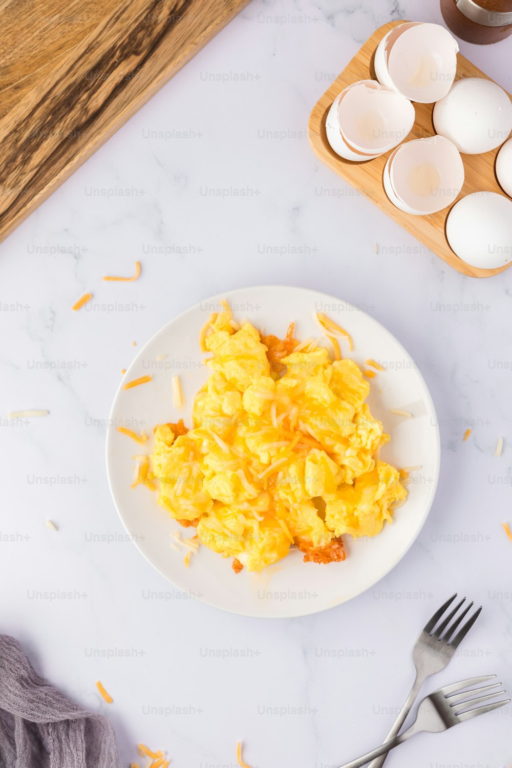 a white plate topped with eggs next to a bowl of eggs