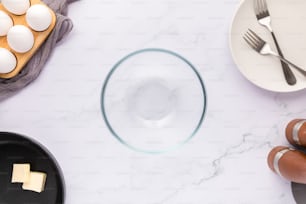 a table topped with plates and bowls filled with eggs